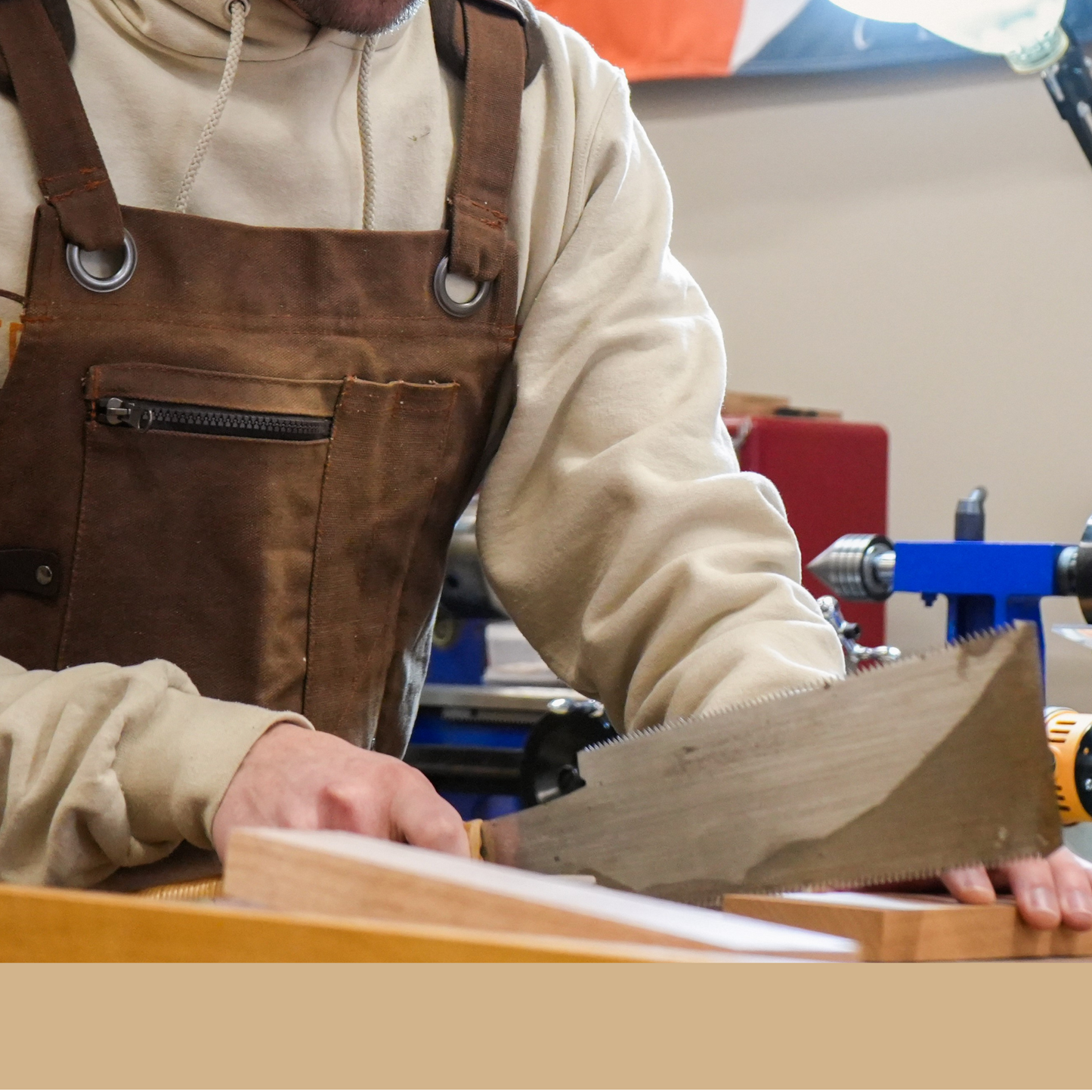 Man working on a project in a workshop with a 'Newport' sign in the background