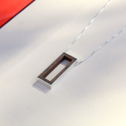 Close up of wood pendant with silver rim