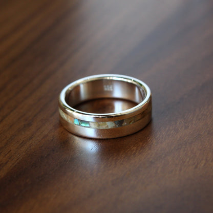 Silver ring on a wooden surface