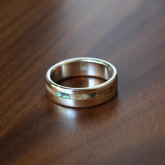 Silver ring on a wooden surface