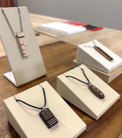 Wooden pendants on stands and boxes on a wooden surface