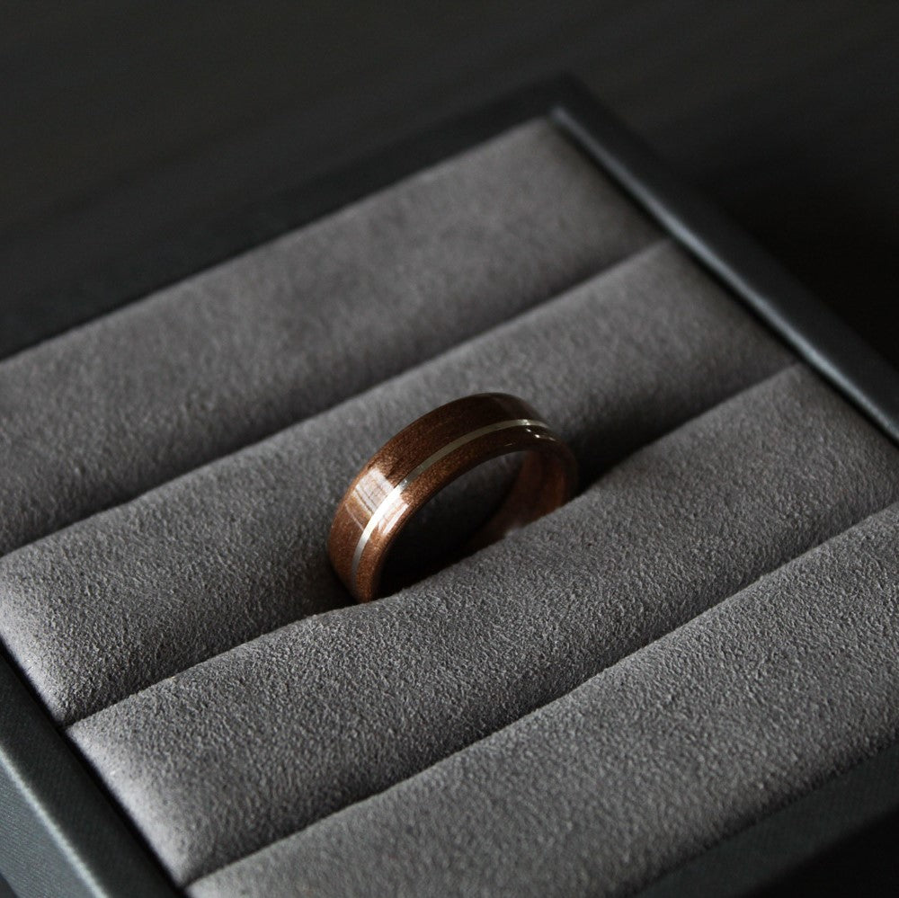 Walnut wood ring with silver inlay